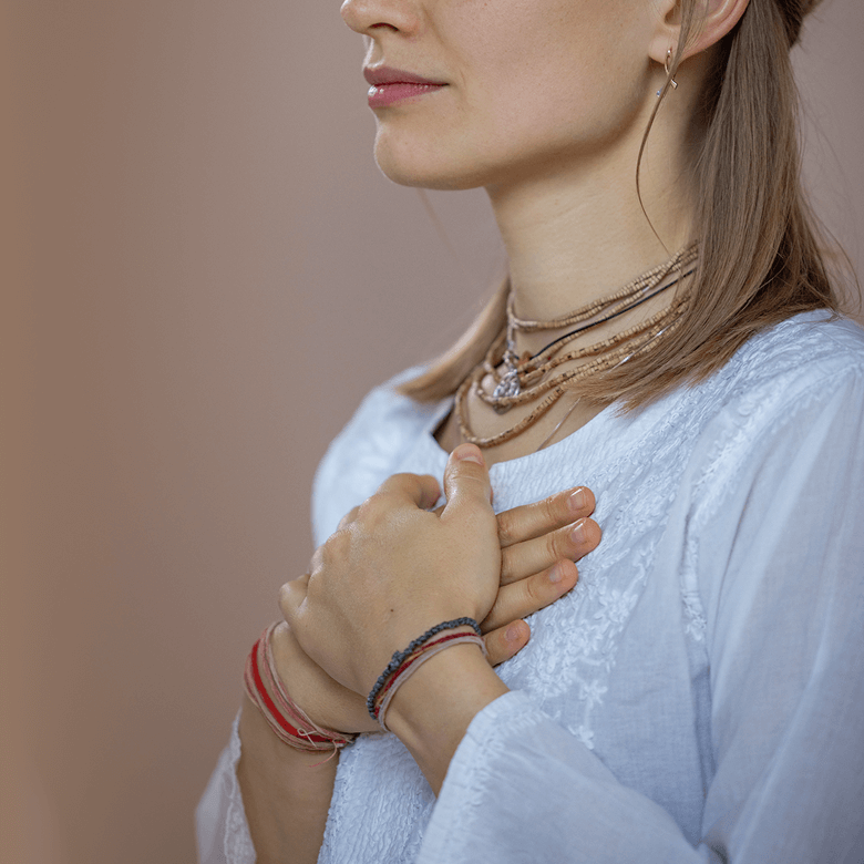 Hands held over heart during meditation