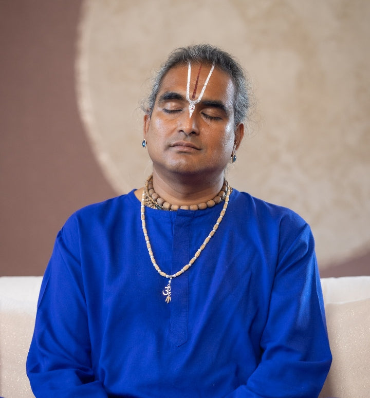 Paramahamsa Vishwananda in meditation, wearing a blue dress